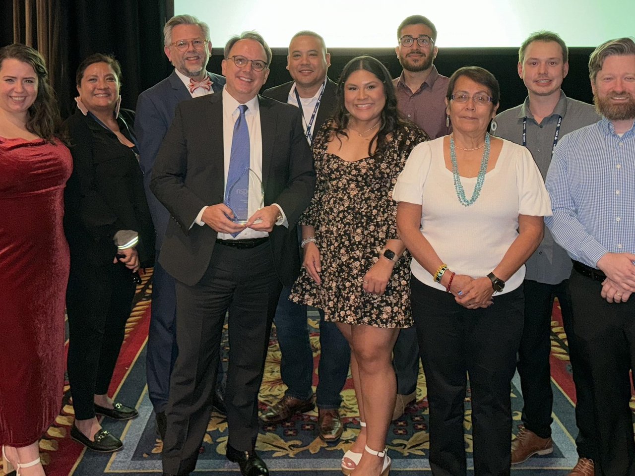 Indigenous Education, Inc. staff with the John Garland awardee at the 2023 NSPA